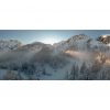 Winter sun flares through the fog on Vršič pass.